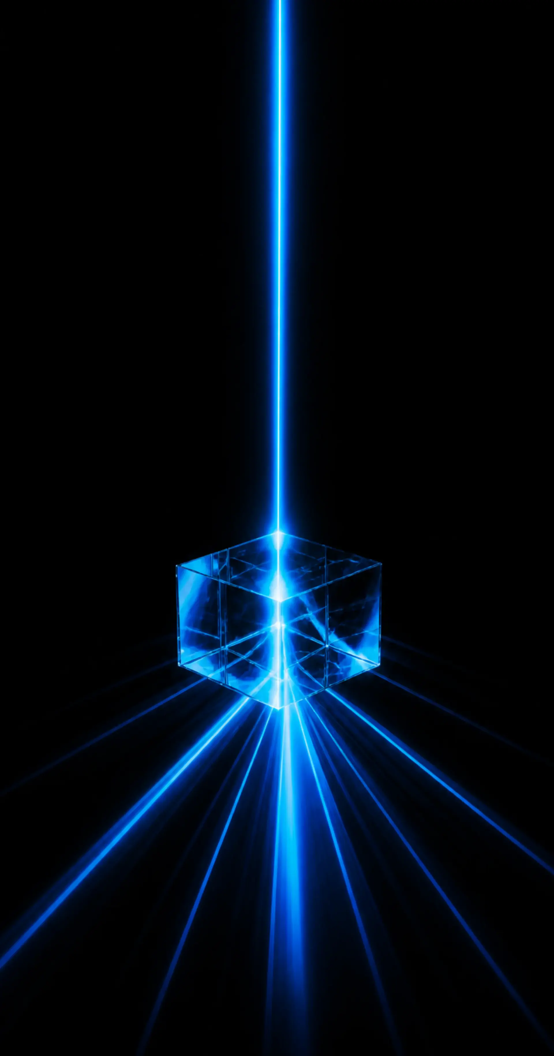 A blue beam strikes a glass cube and fans out